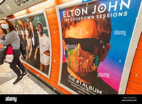 England, London, Subway Station Platform with Elton John Album Advertising Poster and Female ...