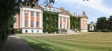 a large building with lots of windows and ivy growing on it's sides