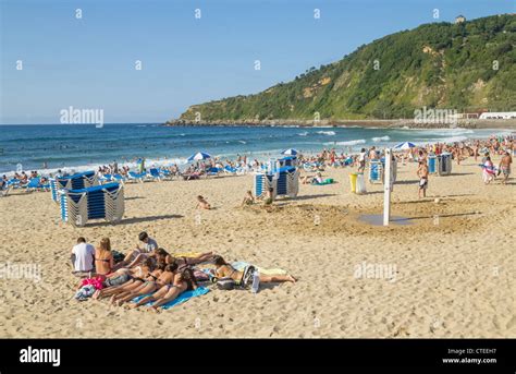 Group of teenage girls sunbathing on Zurriola beach, San Sebastian ...