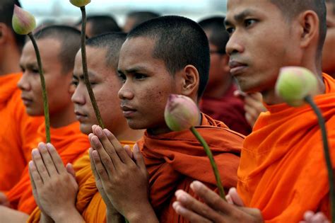 Buddhist monks pray during a march for peace in front of the Royal Palace in Phnom Penh ...