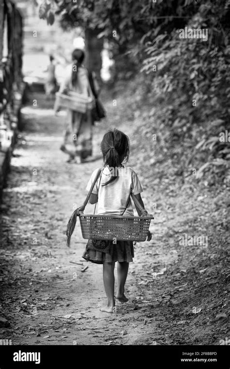 Poverty Cambodia. Mother and barefoot child working together selling ...