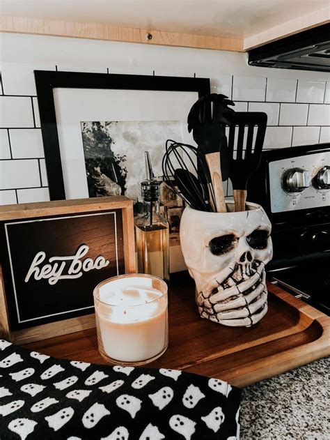 a kitchen counter topped with a skull mask next to a candle
