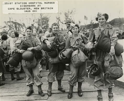 Four nurses in standard issue Army uniform carry all their gear during disembarkation onto Cape ...