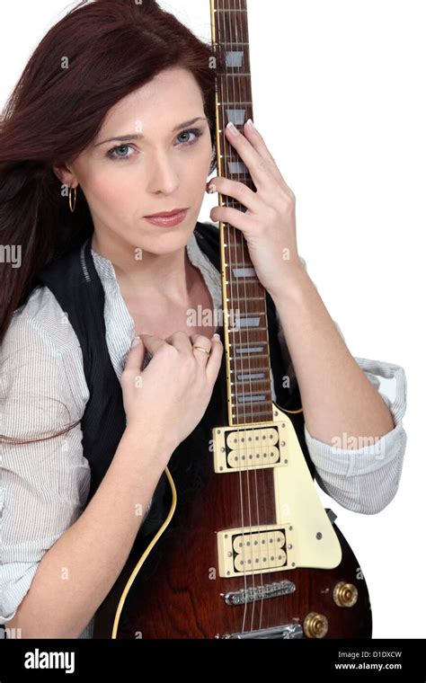 Woman with an electric guitar Stock Photo - Alamy
