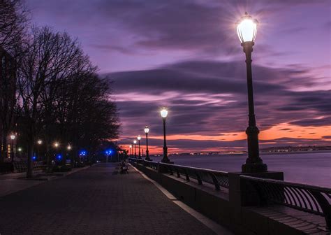 Photography of Turned on Street Lamps Beside Bay during Night Time ...