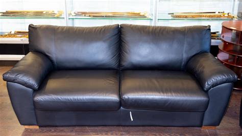 Lot - A black leather Ikea queen size sofa hide-a-bed. 34 1/2 x 77 x 39 in. (87.6 x 195.6 x 99 cm)