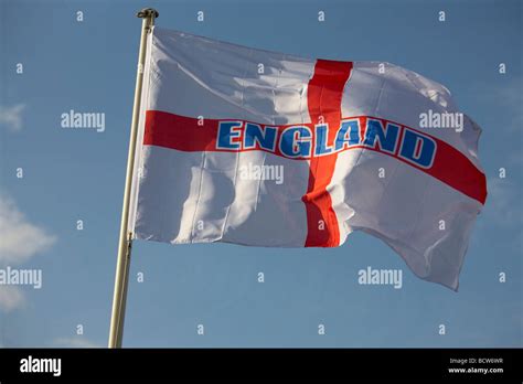 England flag flying against blue sky Stock Photo - Alamy