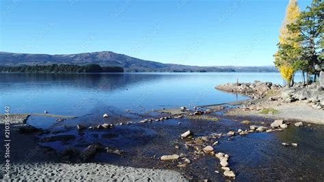 Aerial drone scene of Alumine lake. Camera starts above beach and travels throught the lake ...