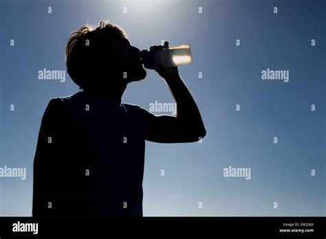 Man drinking from water bottle Stock Photo - Alamy