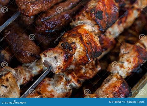 The Closeup of Some Meat Skewers Being Grilled in a Barbecue. Grilled Meat Skewers, Barbecue ...