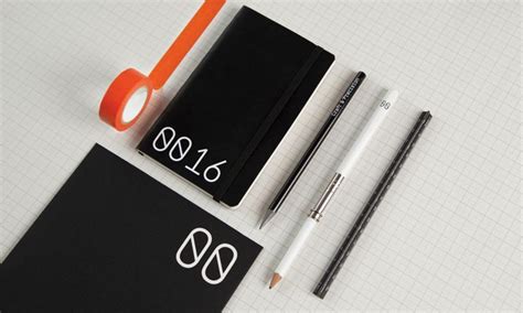 a notepad, pen, pencil and eraser on top of a white table