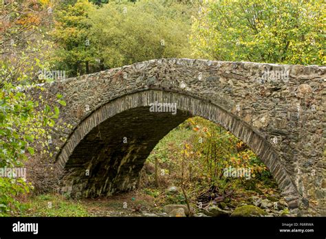 Snowdonia, an Old Stone Bridge partly overgrown. Small arch spanning Stock Photo: 90263414 - Alamy