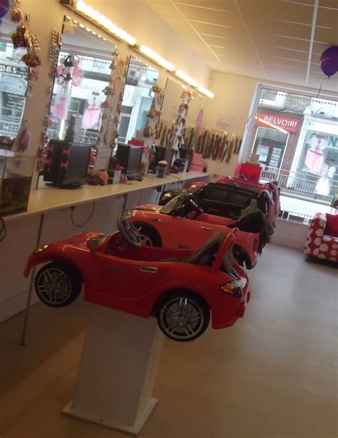 there are many toy cars on display in the store's showroom, and one is red