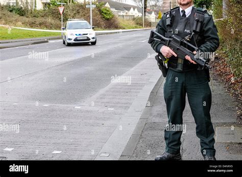 A Police Service of Northern Ireland (PSNI) police officer armed with ...