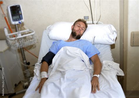 sick patient lying in bed hospital room resting from pain in bad health condition Stock Photo ...