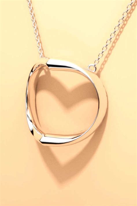 Shadow Heart silver necklace casts silhouette of heart. – OBJECTOUS