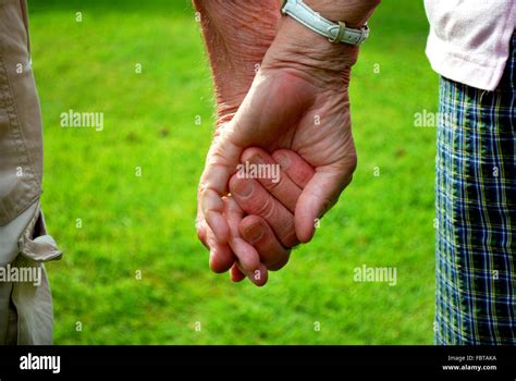 elderly couple holding hands Stock Photo - Alamy