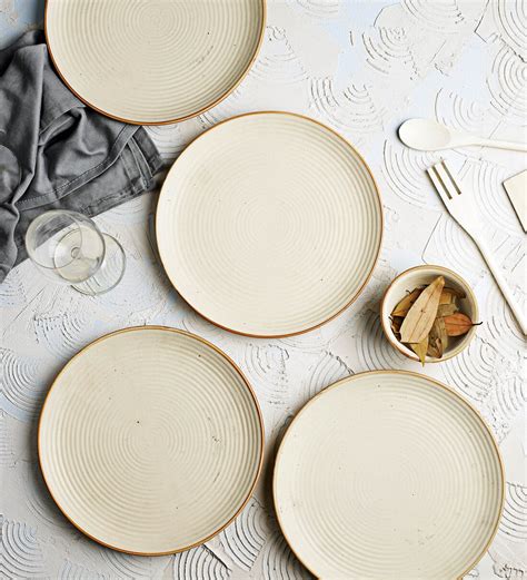 Buy Elora 14 Inch Cream Ceramic (Set of 4) Dinner Plate at 50% OFF by Miah Decor | Pepperfry