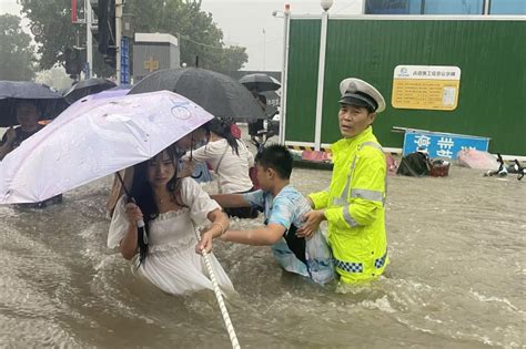 Flood toll rises in central China, as tens of thousands evacuated ...