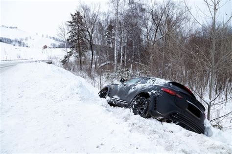 Premium Photo | Accident on a winter snowy track with a black car ...