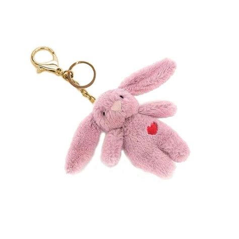 a pink stuffed animal keychain with a heart on it's chest and ears