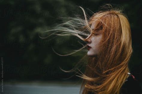 Portrait of a ginger haired young woman with hair blowing in the wind by Jovana Rikalo for ...