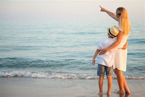 Family Walking on the Evening Beach during Sunset. Stock Image - Image ...