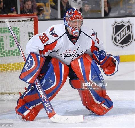 the goalie is waiting for the puck to come down