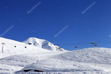 Gondola lift and ski slope at nice day Stock Photo by ©Lizard 35197855