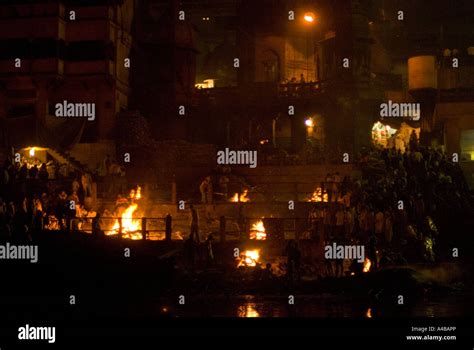 Stock image of the cremation ghat at night with fires in Varanasi Stock ...