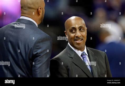 Washington coach Lorenzo Romar, right, greets a member of the Arizona State coaching staff ...