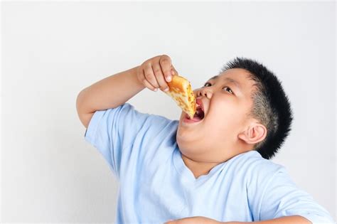 Premium Photo | Fat kid eating pizza. Childhood obesity concept