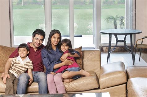 Portrait Of Happy Indian Family Of Four Sitting Together On Sofa Photo ...