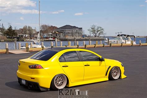 Online crop | yellow sedan, car, yellow cars, Mitsubishi Lancer Evo X, harbor HD wallpaper ...