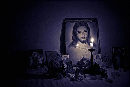 Royalty-Free photo: Lighted candle near crucifix photo | PickPik