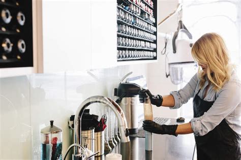 Woman in protective gloves cleaning equipment at hair salon. — sink, selective focus - Stock ...