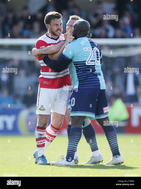 Wycombe Wanderers Adebayo Akinfenwa (right) tries to calm down ...