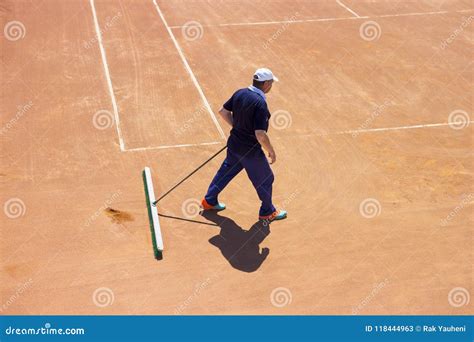 Preparation of a Ground Tennis Court. a Man is Cleaning a Tennis Court Editorial Stock Photo ...