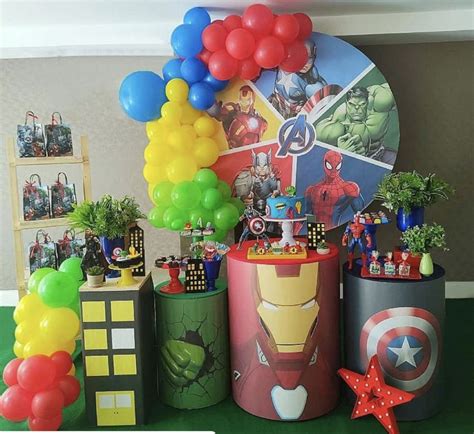 a birthday party with balloons, decorations and pictures on the wall behind it is an iron man theme