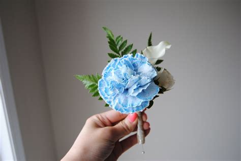Blue and white boutonniere. Made with blue carnation, mini white calla and white spray rose ...