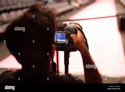 Photographer setting camera Stock Photo - Alamy