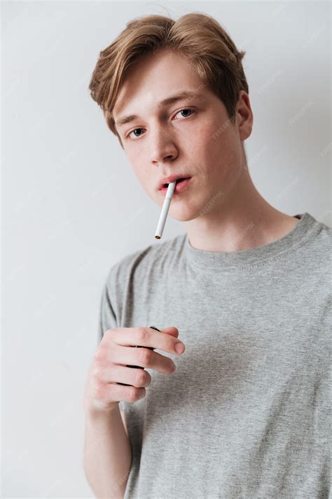 Premium Photo | Vertical image of calm young man smoking cigarette