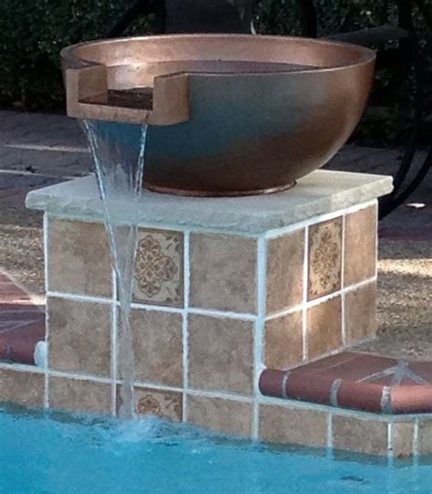 a large bowl sitting on top of a fountain