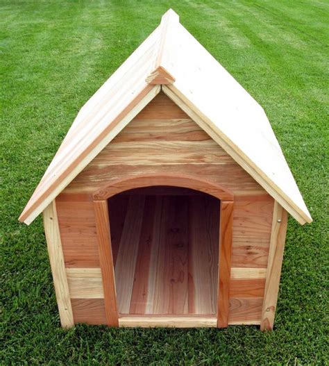 a dog house made out of wood on the grass