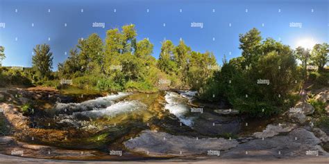 360° view of 360 panorama of a mountain couple next to a river, with many trees and plants and ...