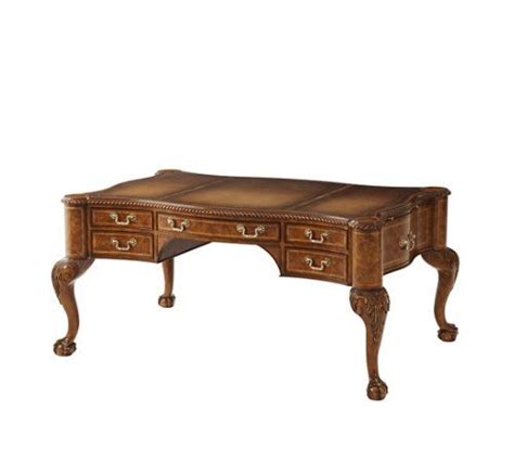 A fine walnut burl veneered and carved mahogany writing desk, the serpentine top with a ...