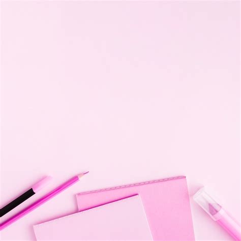 Pink stationery set on colored surface Photo | Free Download