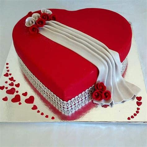 a heart shaped cake with red and white decorations