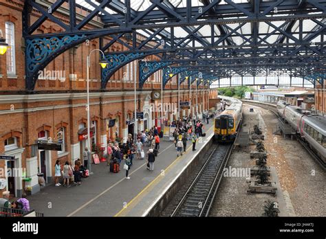 Travelers waiting for a train at Bournemouth railway station in Dorset, England Stock Photo - Alamy