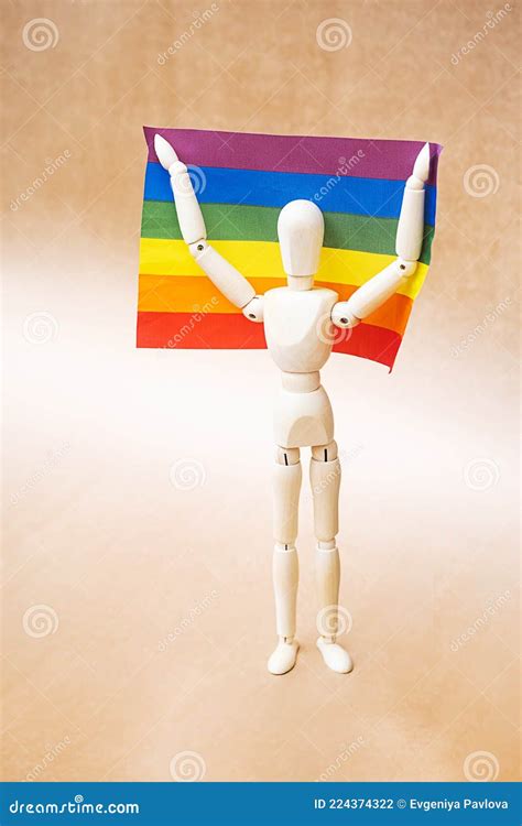 LGBT Gay Pride Flag. Wooden Human Mannequin Figure Hold a Rainbow Flag. Equal Rights for Lgbtq ...